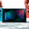 Console Nintendo Switch noire avec manettes Joy-Con droite rouge néon et Joy-Con gauche bleue néon – Image 3